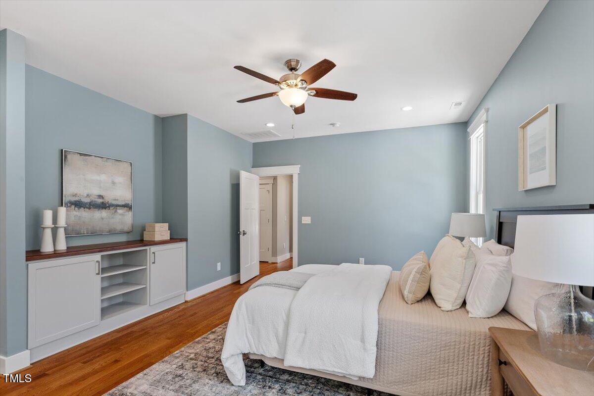 3932 Old Chapel Hill Road Durham, NC 27707 - Photo 24 of 46 a bedroom with a bed and dresser with mirror
