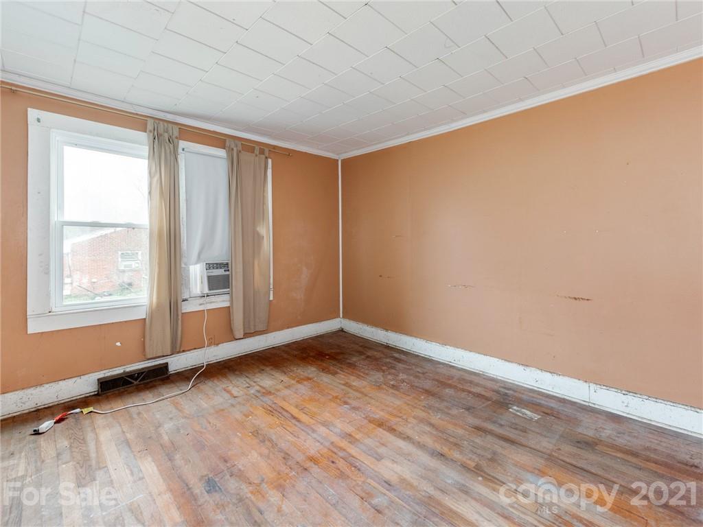 179 Harris Holly Springs Road Rutherfordton, NC 28139 - Photo 13 of 24 a view of an empty room with wooden floor and a window
