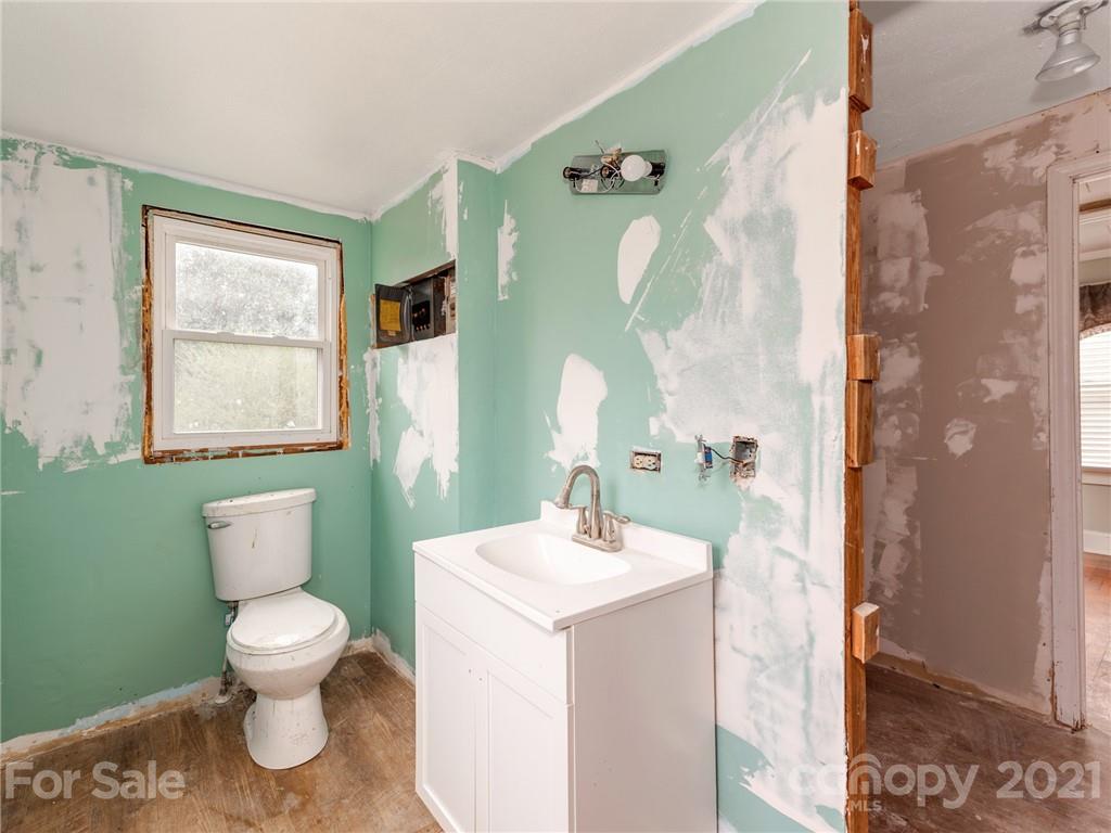 179 Harris Holly Springs Road Rutherfordton, NC 28139 - Photo 21 of 24 a bathroom with a toilet sink and mirror