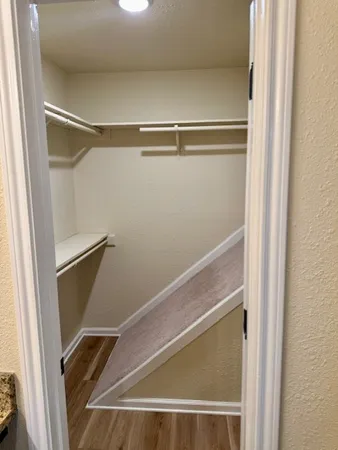 a view of walk in closet with empty racks
