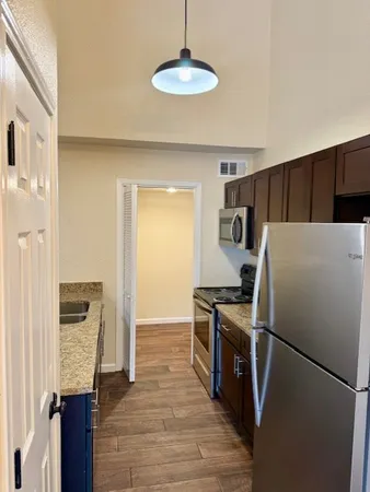 a kitchen with stainless steel appliances a refrigerator and a stove