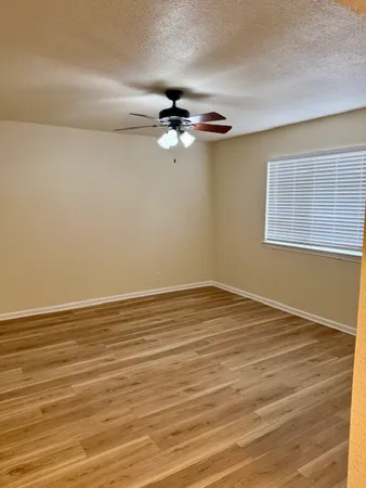 wooden floor in an empty room with a window