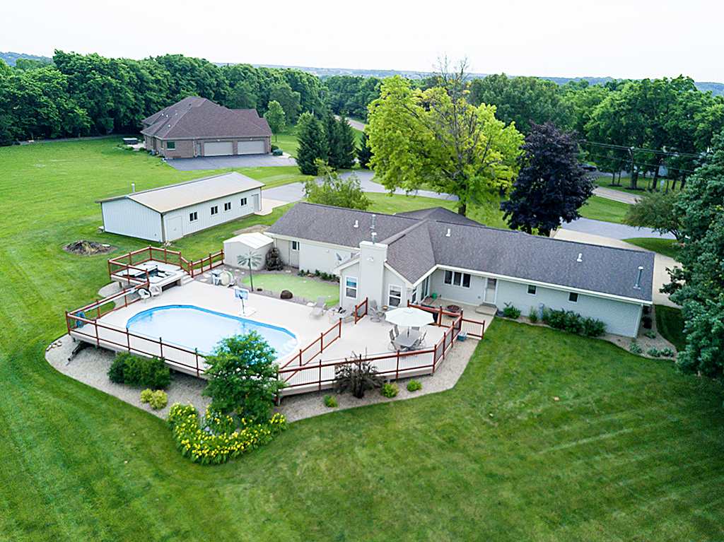 an aerial view of a house with garden space and a street view