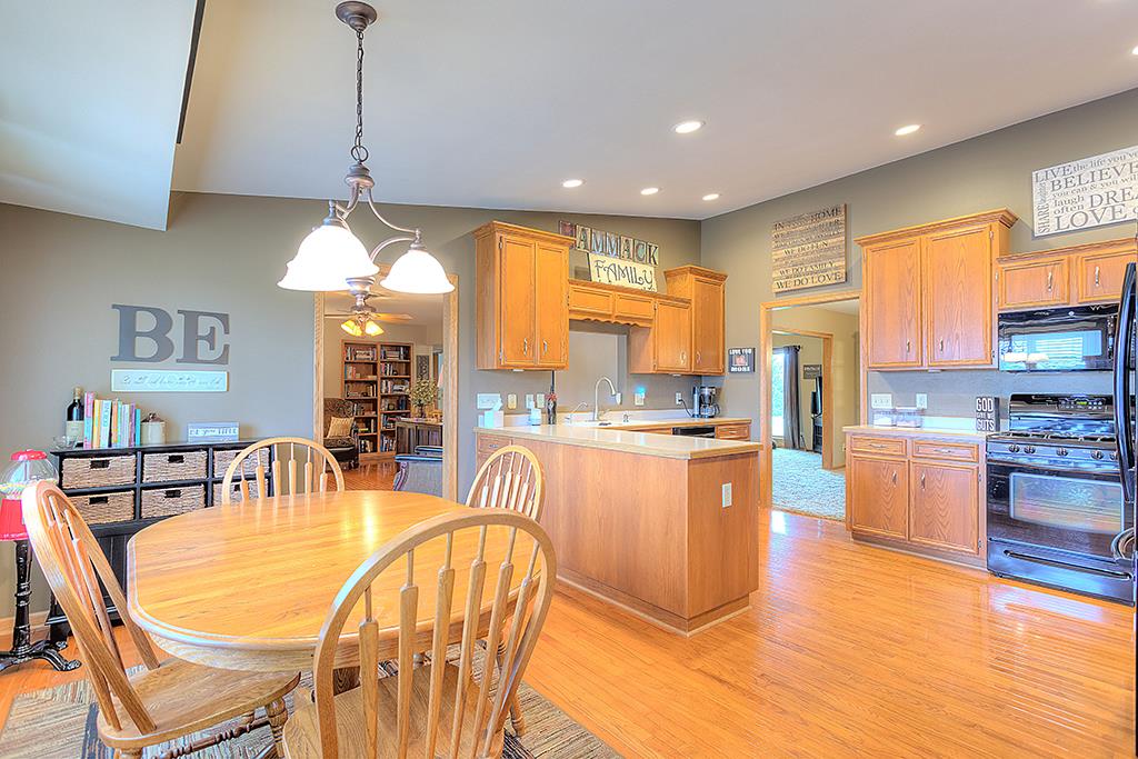 5948 Mc Donald Road Roscoe, IL 61073 - Photo 14 of 24 a large kitchen with a table and chairs