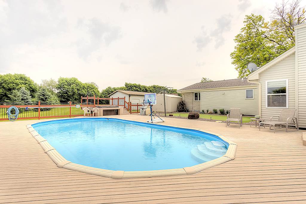 5948 Mc Donald Road Roscoe, IL 61073 - Photo 2 of 24 a view of a swimming pool with a lounge chair