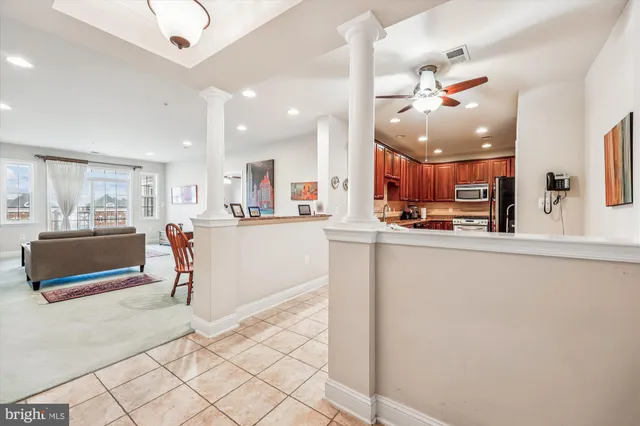 a kitchen with a refrigerator and a counter top space