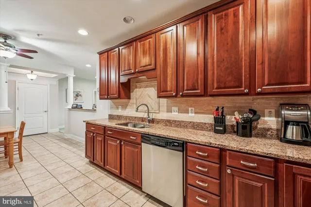 a kitchen with stainless steel appliances granite countertop a sink stove and cabinets