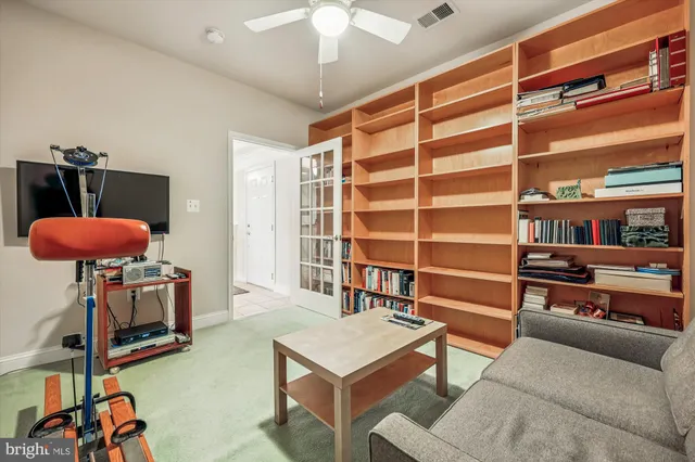 a spacious bedroom with a bed and a chandelier