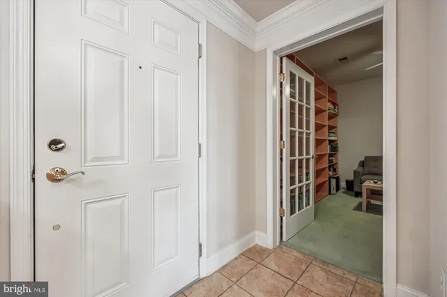 a view of a hallway with wooden shelves