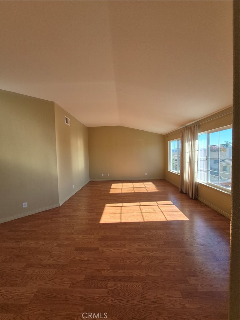 28841 Tonya Street Murrieta, CA 92563 - Photo 11 of 12 an empty room with wooden floor and windows