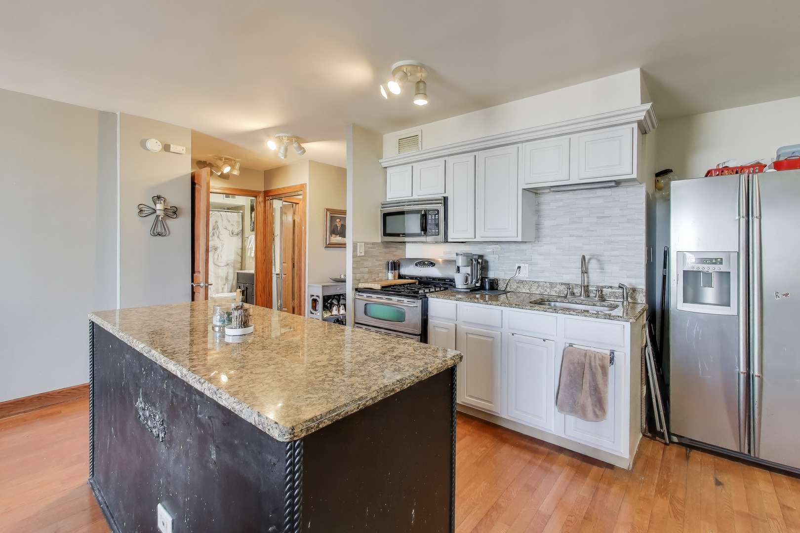 20 North Tower Road, Unit 8E Oak Brook, IL 60523 - Photo 13 of 31 a kitchen with stainless steel appliances granite countertop a refrigerator a stove and a sink