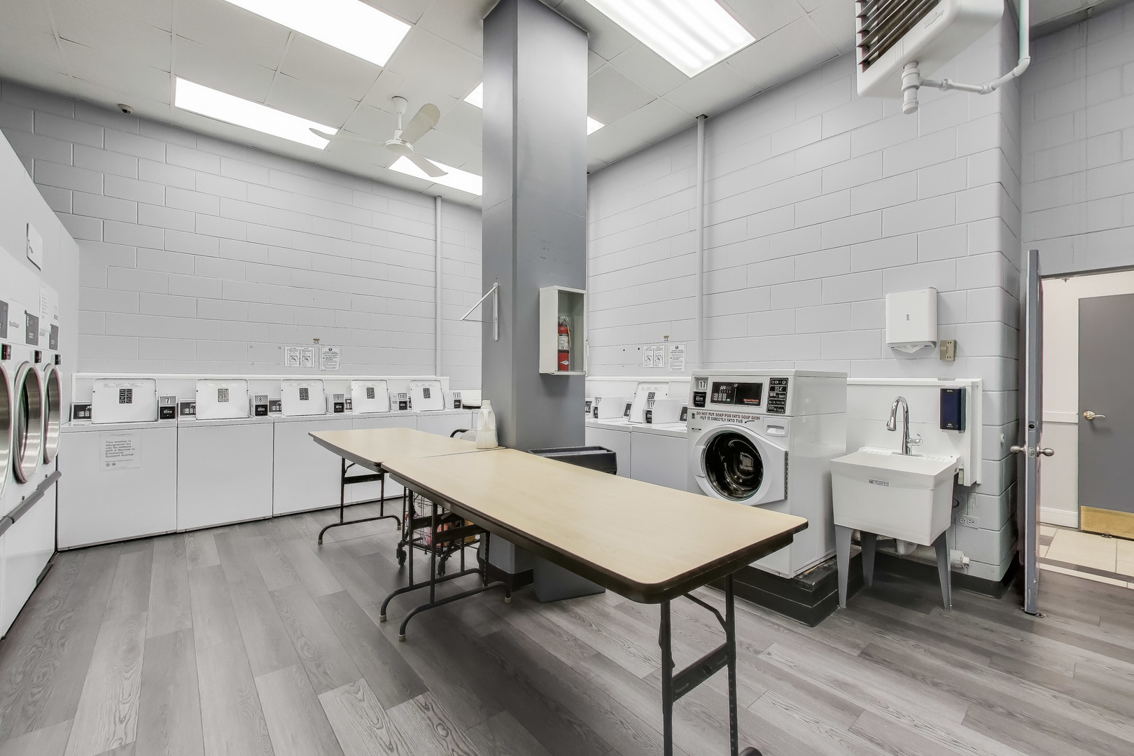 20 North Tower Road, Unit 8E Oak Brook, IL 60523 - Photo 26 of 31 a kitchen with a table chairs sink and cabinets