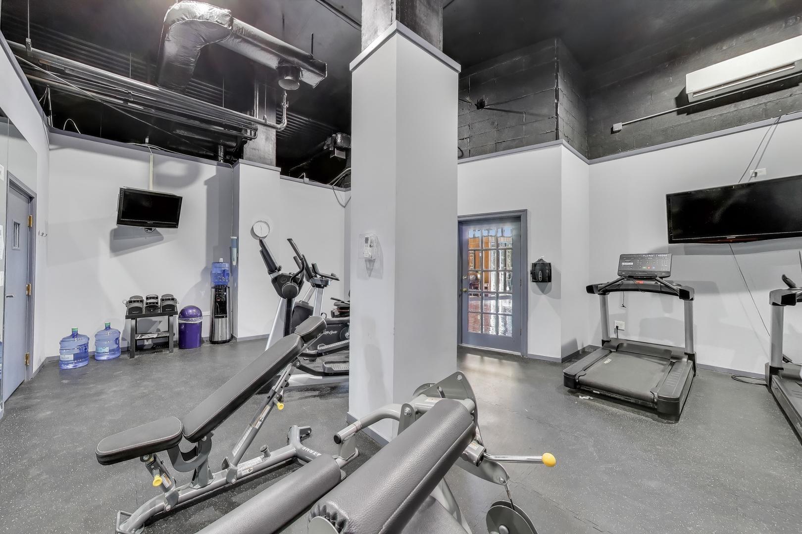 20 North Tower Road, Unit 8E Oak Brook, IL 60523 - Photo 28 of 31 a room with gym equipment and a flat screen tv