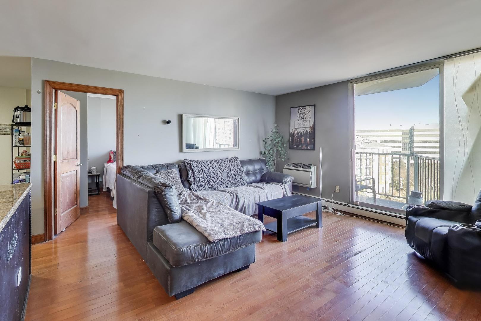 20 North Tower Road, Unit 8E Oak Brook, IL 60523 - Photo 7 of 31 a living room with furniture and a wooden floor