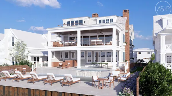 a view of a white house with large windows and a table and chairs