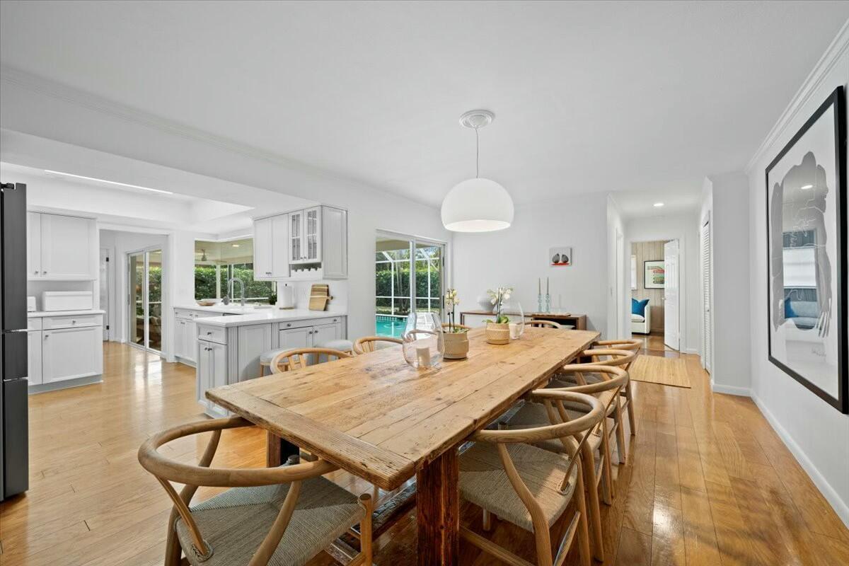 232 Cove Place Jupiter, FL 33469 - Photo 25 of 67 a view of a dining room with furniture and wooden floor