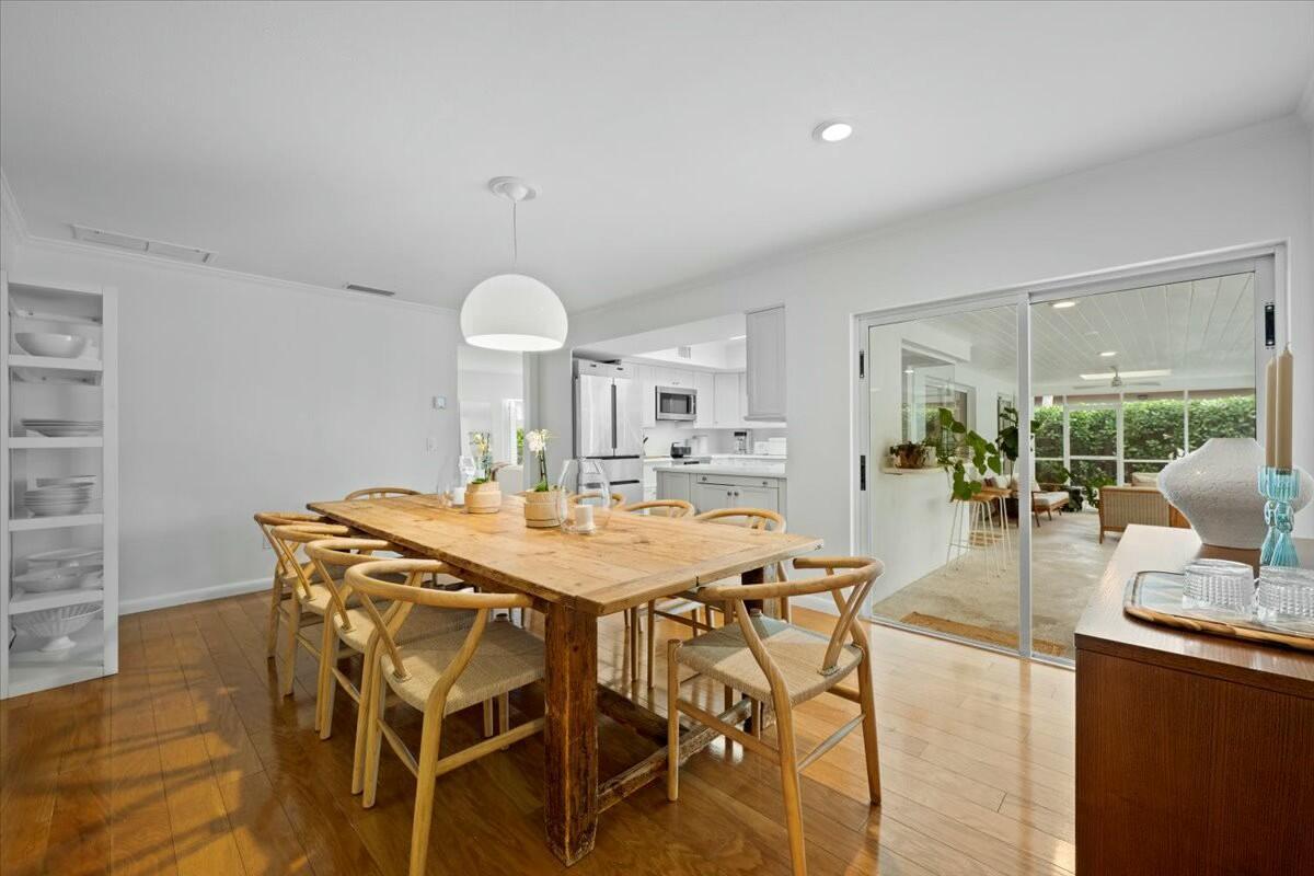 232 Cove Place Jupiter, FL 33469 - Photo 28 of 67 a view of a dining room with furniture and wooden floor