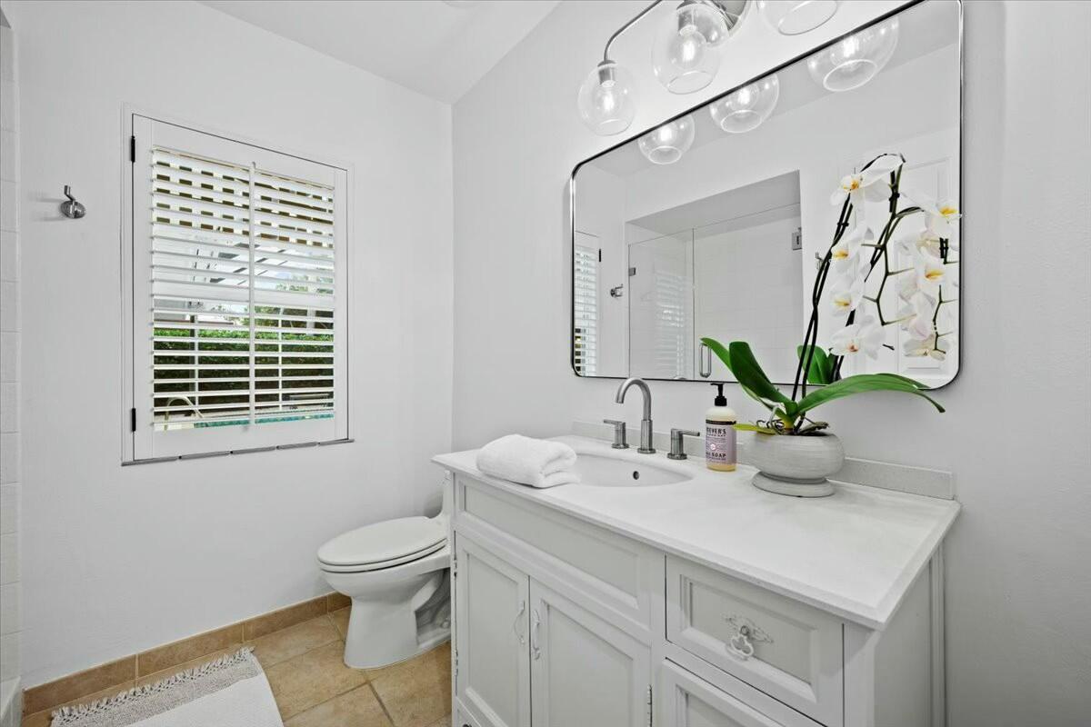 232 Cove Place Jupiter, FL 33469 - Photo 31 of 67 a bathroom with a sink a toilet and mirror