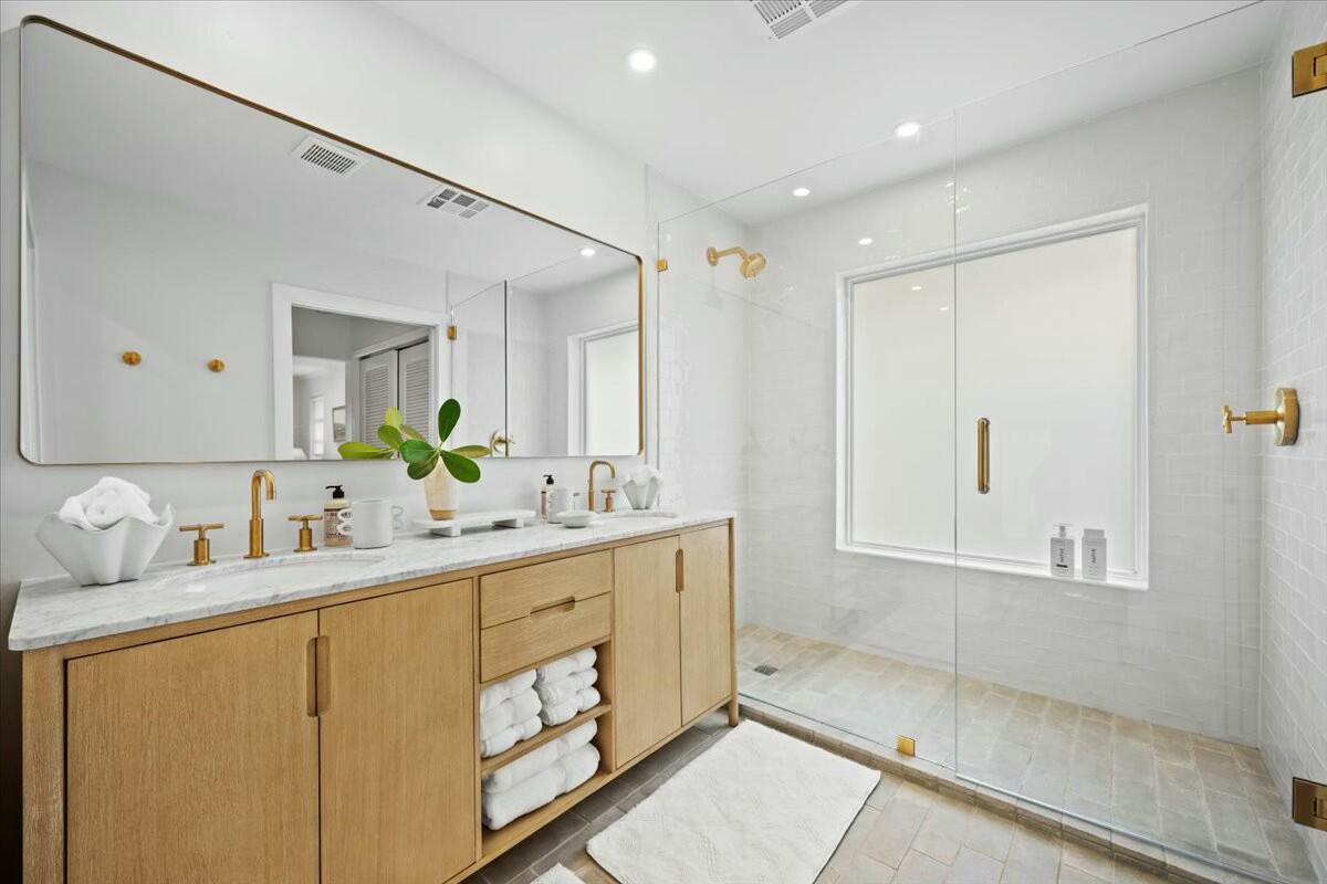 232 Cove Place Jupiter, FL 33469 - Photo 38 of 67 a bathroom with a double vanity sink mirror and shower