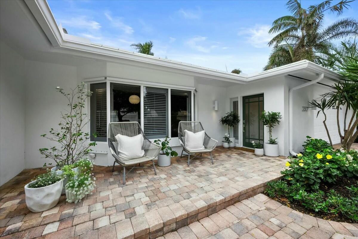 232 Cove Place Jupiter, FL 33469 - Photo 4 of 67 a view of a house with sitting area and garden