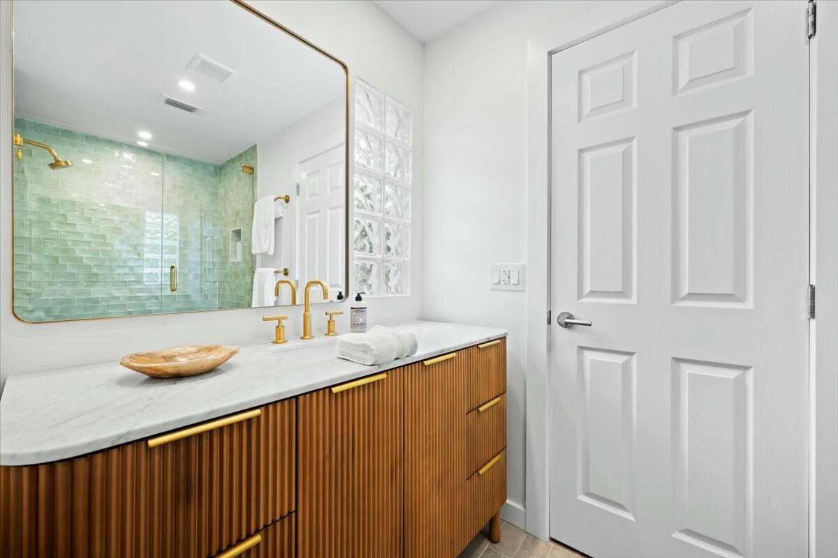 232 Cove Place Jupiter, FL 33469 - Photo 42 of 67 a bathroom with a sink and a mirror