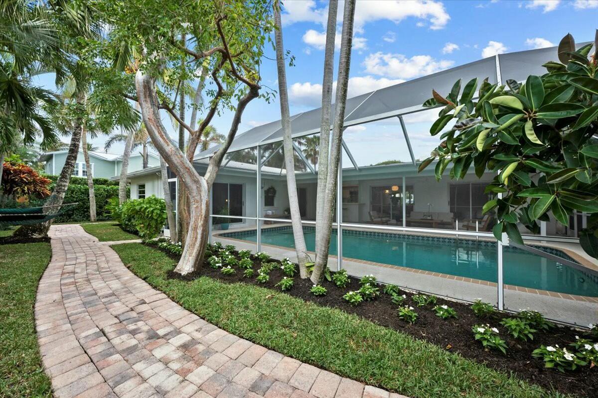232 Cove Place Jupiter, FL 33469 - Photo 50 of 67 a garden with trees in front of it