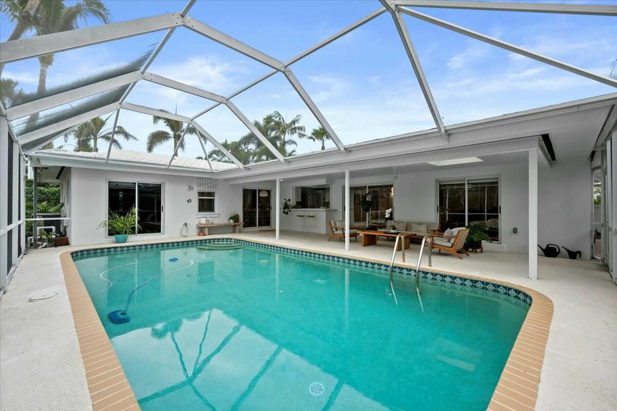 232 Cove Place Jupiter, FL 33469 - Photo 53 of 67 a view of a house with swimming pool porch and furniture