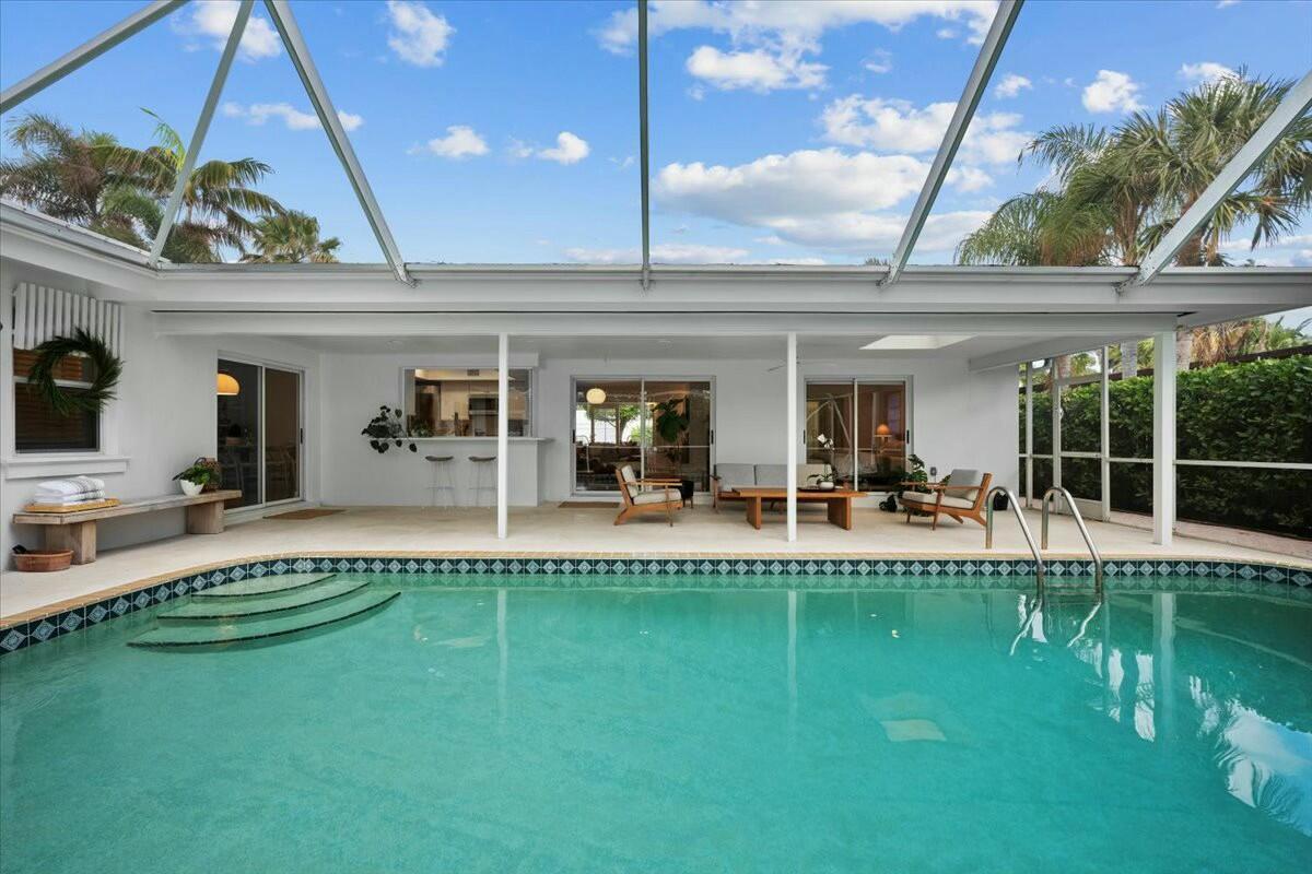 232 Cove Place Jupiter, FL 33469 - Photo 54 of 67 a view of a swimming pool with a patio and a yard