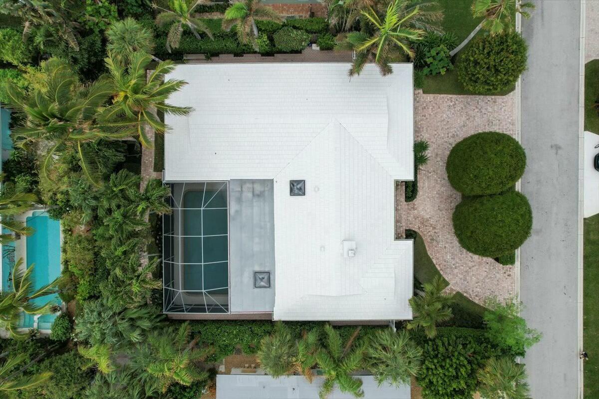 232 Cove Place Jupiter, FL 33469 - Photo 65 of 67 a view of a small yard in front of a house with wooden fence