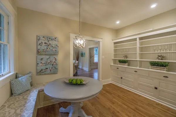 a large kitchen with kitchen island a large counter top space a sink stainless steel appliances and cabinets