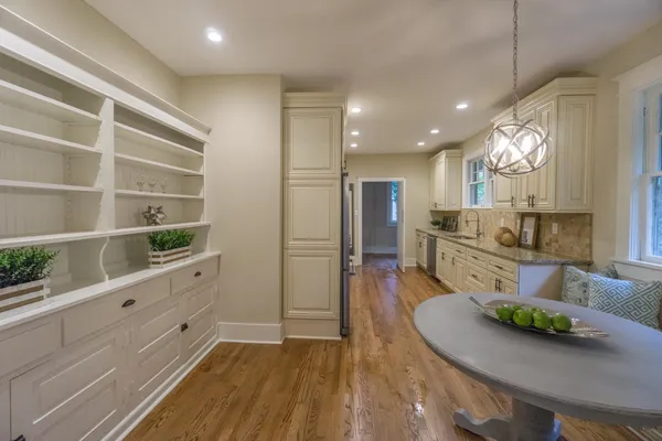 a bedroom with a bed and a flat tv screen on dresser