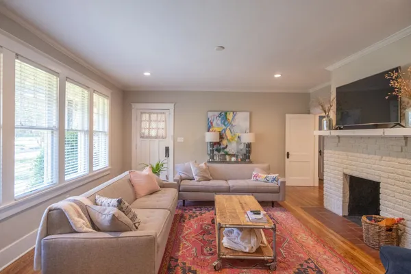 a living room with furniture and a fireplace