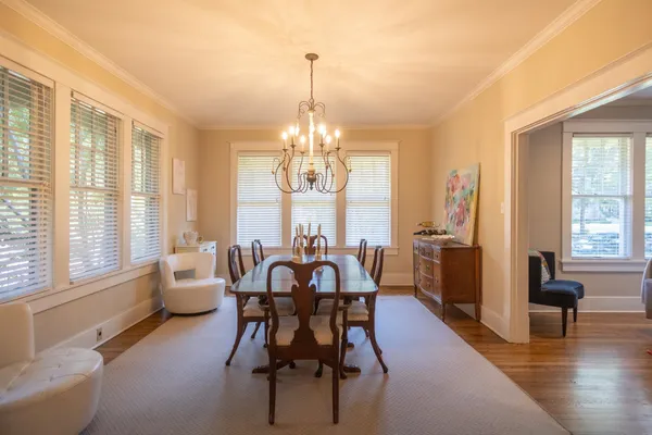 a view of a dining room with furniture windows and wooden floor