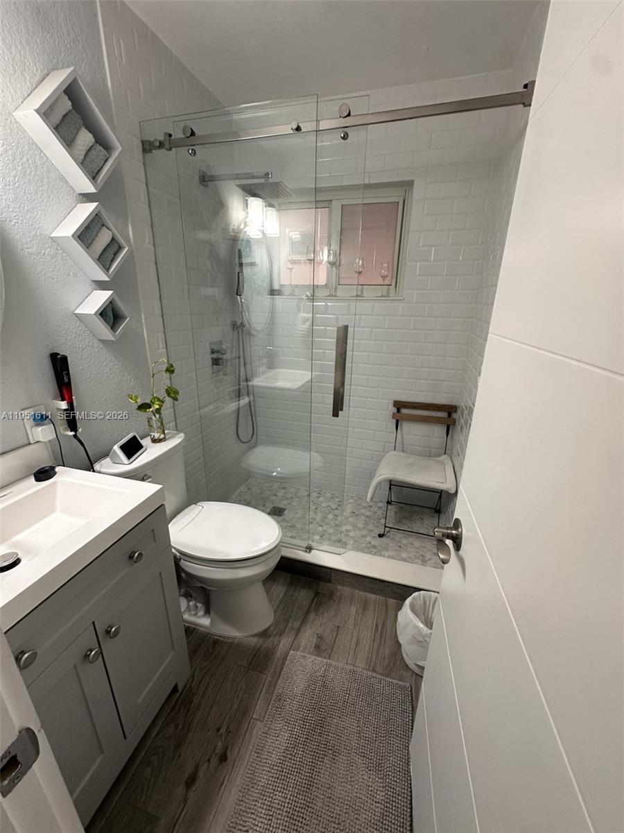 4485 Southwest 7th Street Miami, FL 33134 - Photo 18 of 26 a bathroom with a toilet a sink and shower