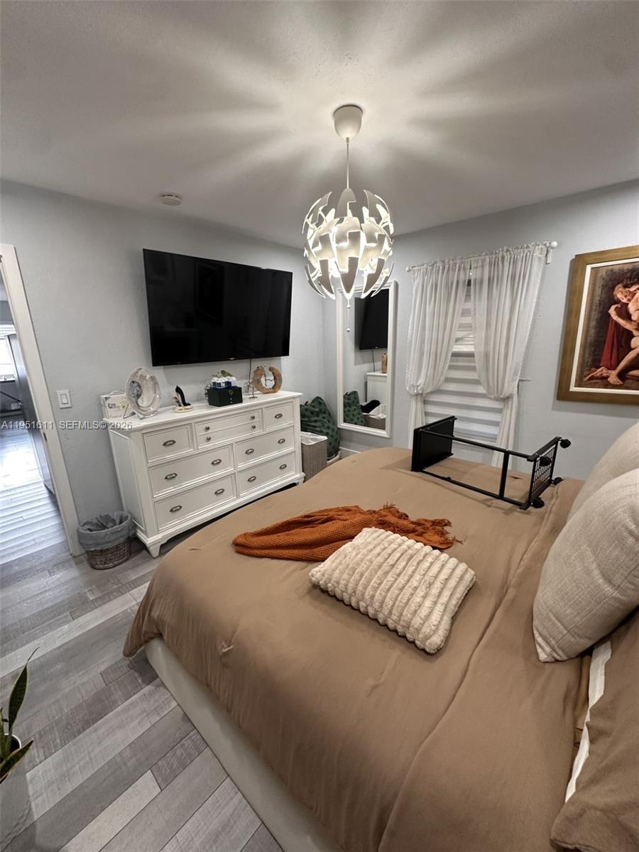 4485 Southwest 7th Street Miami, FL 33134 - Photo 26 of 26 a bedroom with a bed and a flat screen tv