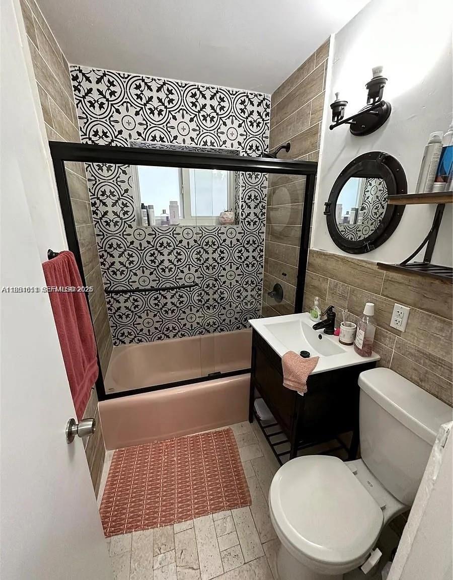 4485 Southwest 7th Street Miami, FL 33134 - Photo 10 of 26 a bathroom with a sink mirror vanity and toilet