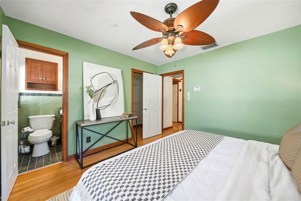 1715 Canton Street Orlando, FL 32803 - Photo 24 of 31 a bedroom with a bed and a chandelier