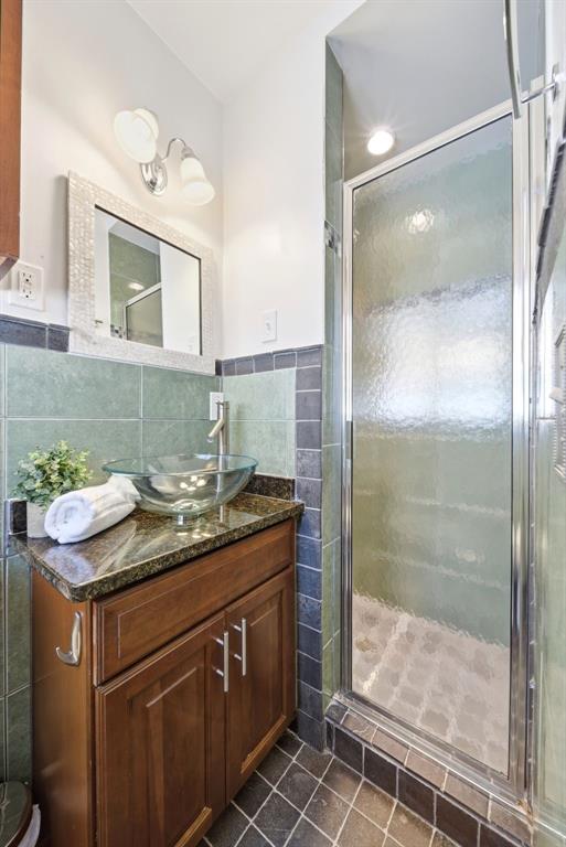 1715 Canton Street Orlando, FL 32803 - Photo 26 of 31 a bathroom with a granite countertop sink a mirror and shower