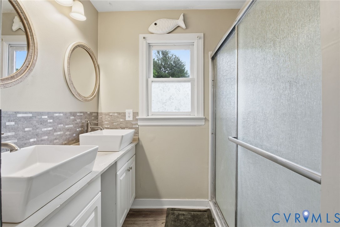9110 Gayton Road Henrico, VA 23229 - Photo 26 of 54 a bathroom with a granite countertop sink a mirror and a shower