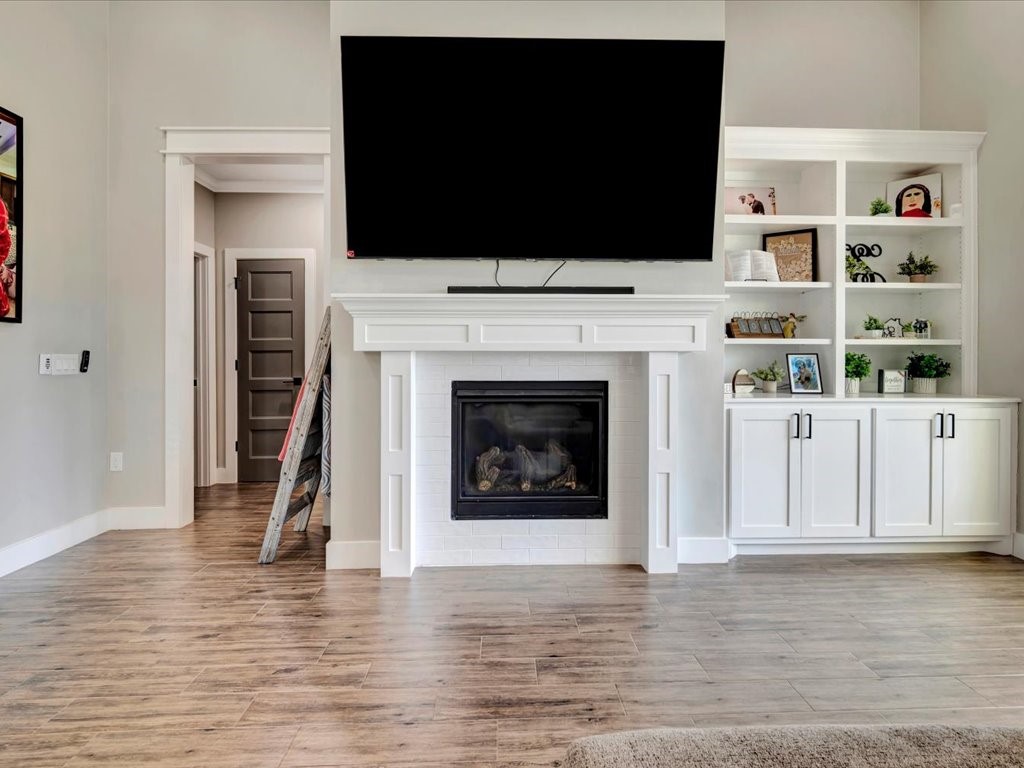 387 C C Road Diboll, TX 75941 - Photo 14 of 50 a living room with a flat screen tv and a fireplace