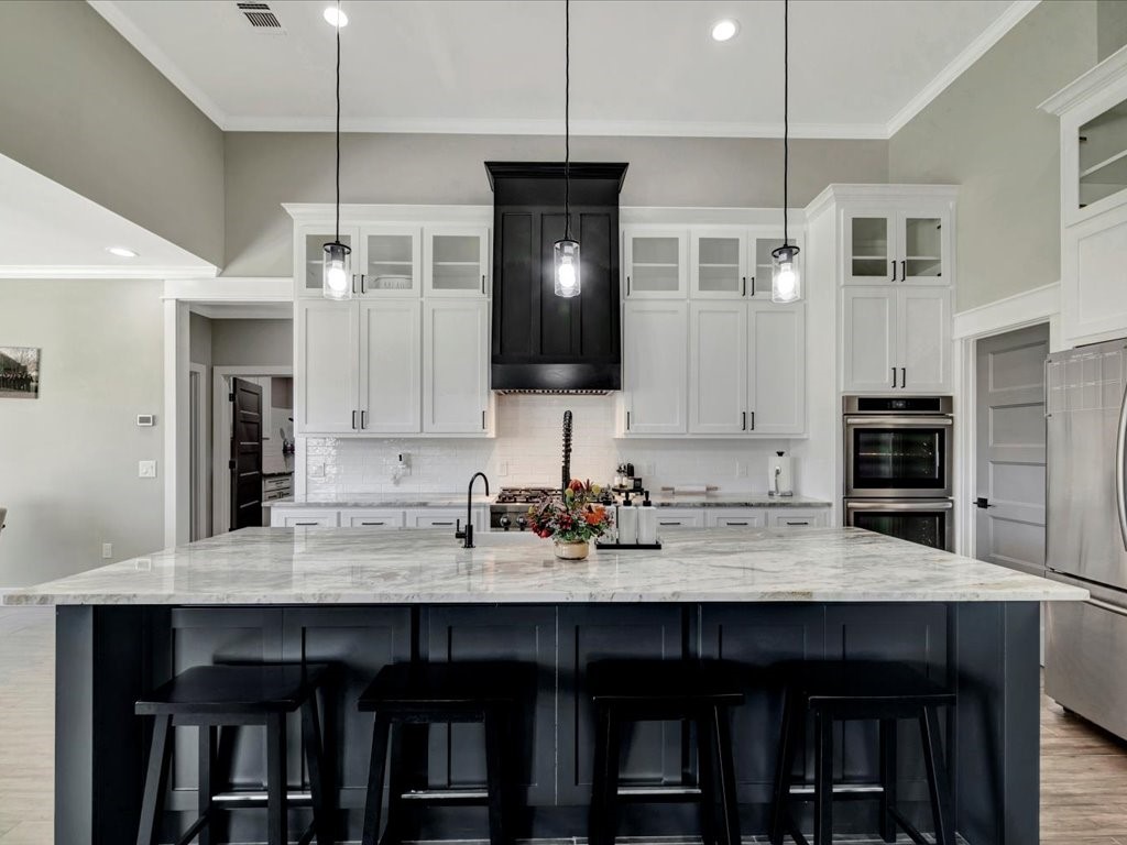 387 C C Road Diboll, TX 75941 - Photo 17 of 50 a kitchen with a wooden floor and chairs