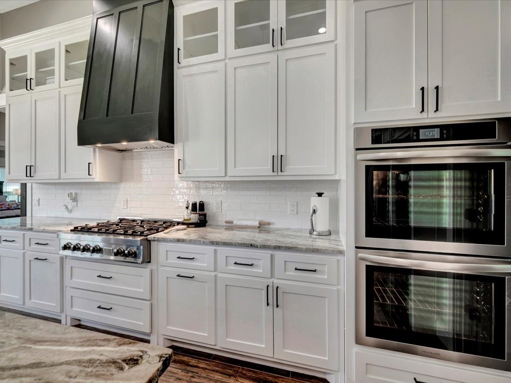 387 C C Road Diboll, TX 75941 - Photo 21 of 50 a kitchen with granite countertop white cabinets and stainless steel appliances