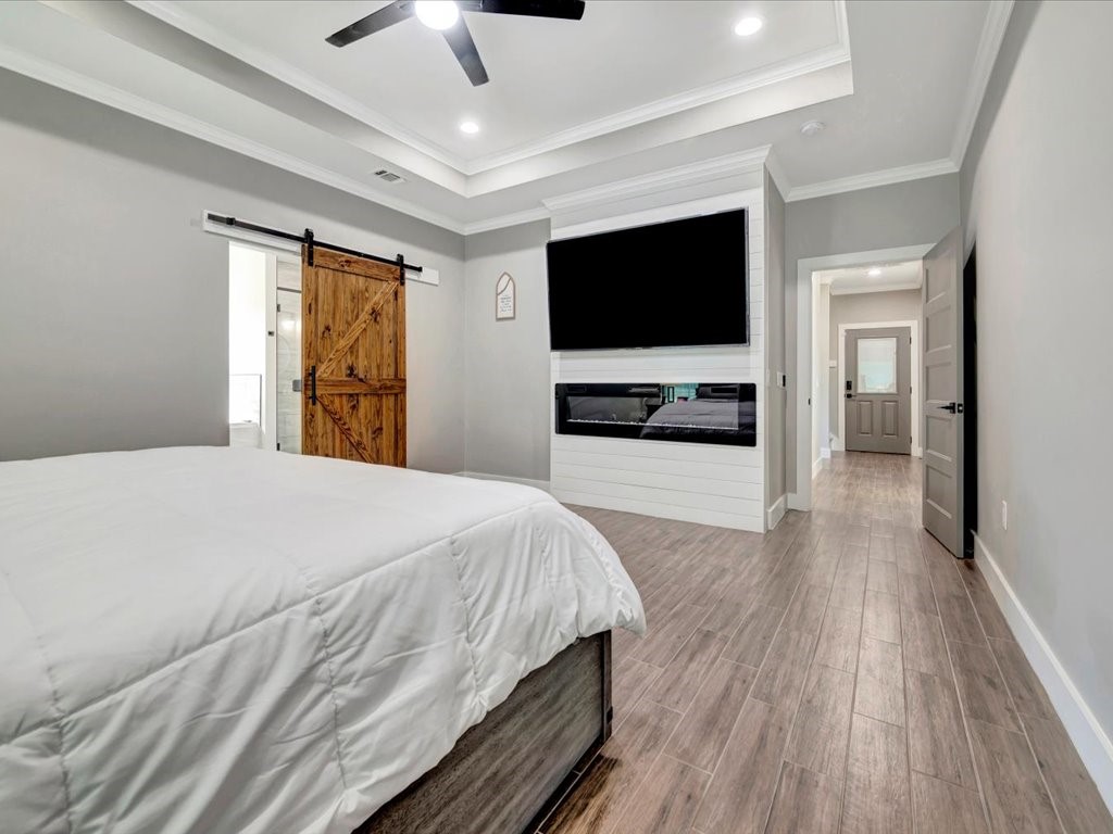 387 C C Road Diboll, TX 75941 - Photo 26 of 50 a bedroom with a bed and a flat screen tv