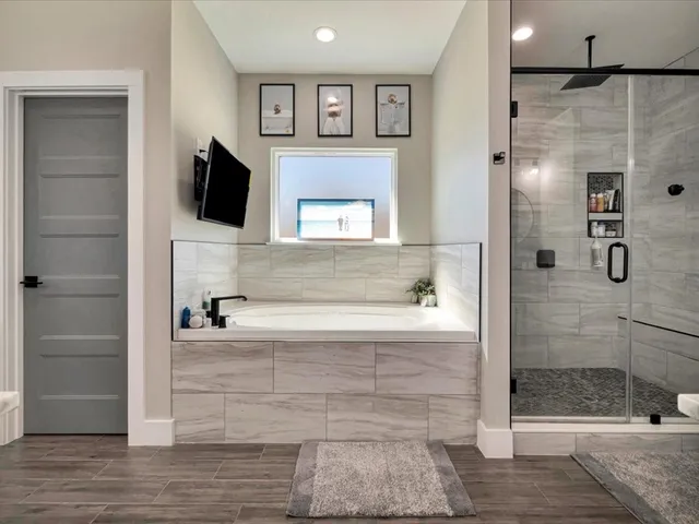a bathroom with a bathtub and a shower