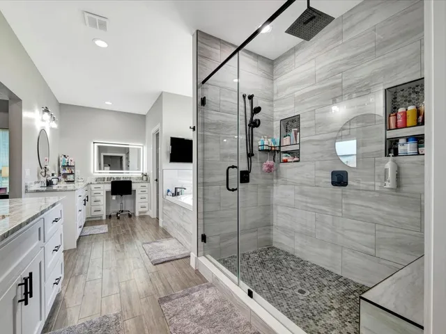 a bathroom with a sink a mirror and shower