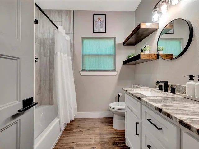 a bathroom with a toilet a sink and a mirror