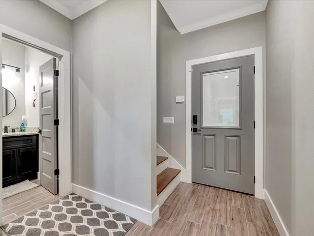 a view of a hallway with wooden floor and closet