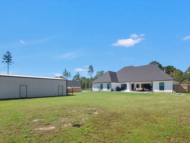 a front view of a house with a garden and yard