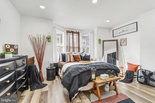 a bedroom with a bed furniture and a flat tv screen