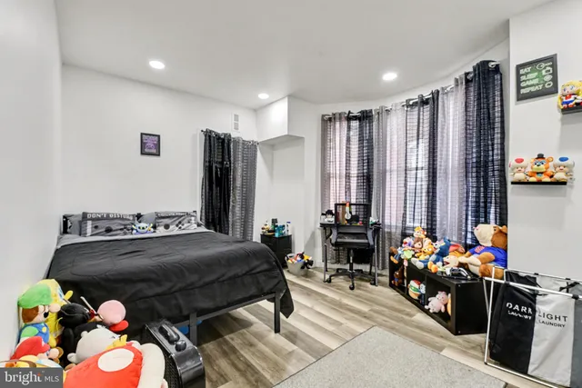 a bedroom with filled bed and a window